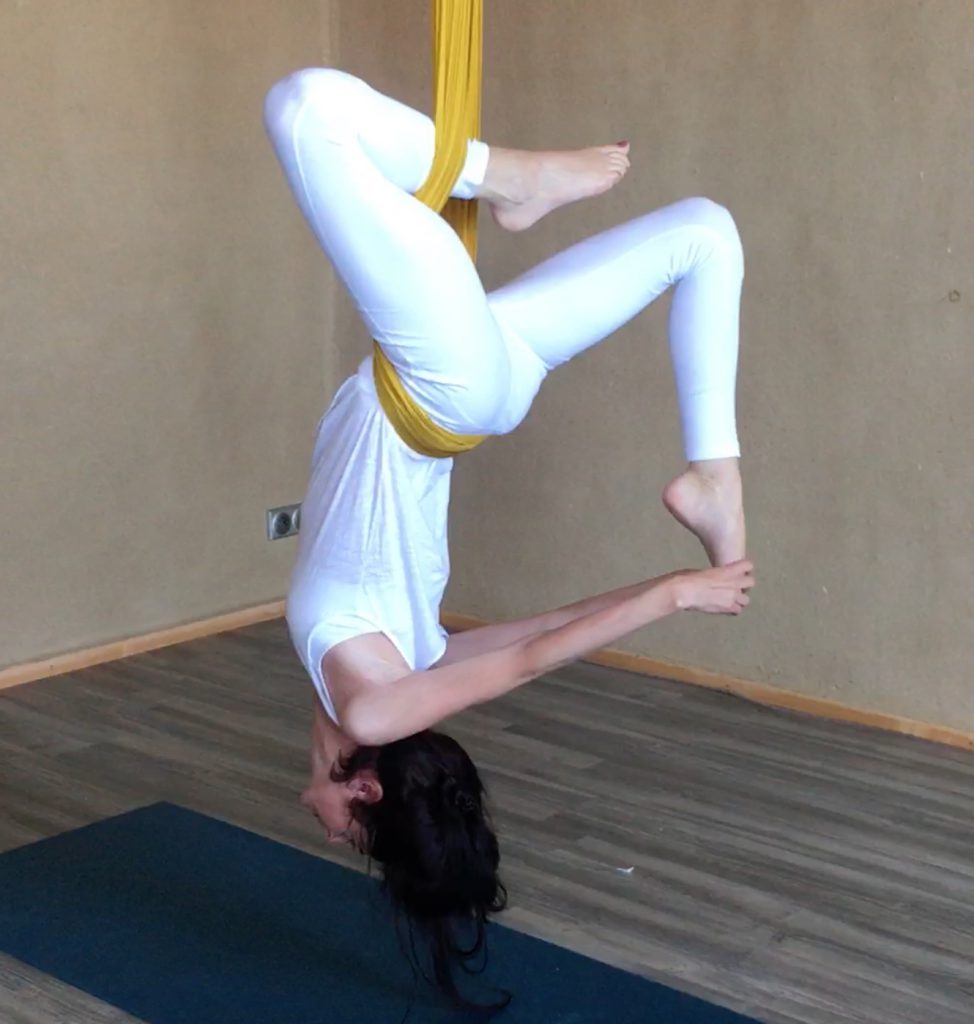 Tanja Hettich in an aerial yoga pose